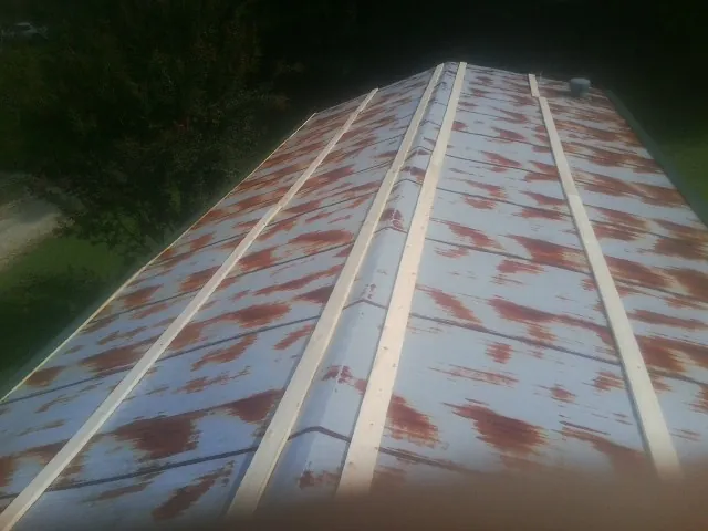 Rusted metal roof panels with new wood purlins before replacement — Storm Damage Roof Repair in King Of Prussia by Roofing Brothers